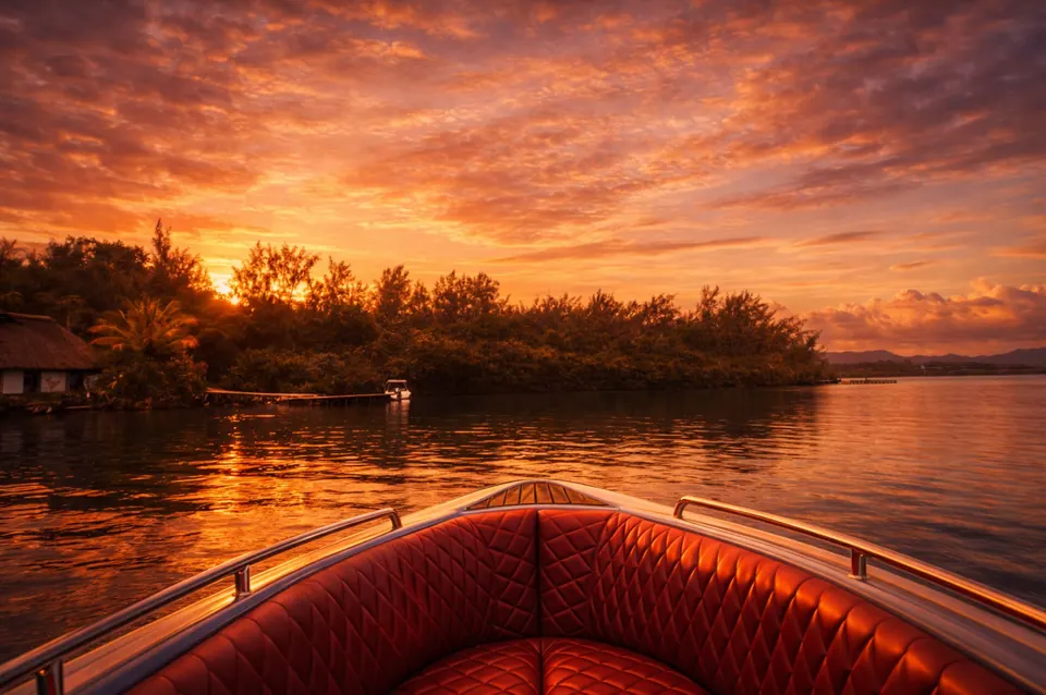 Sunset over the lagoon from the bow of a luxury speedboat in Trou d Eau Douce